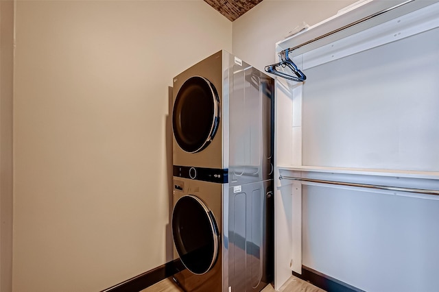 505 Bastrop St Unit 508, Houston, TX 77003 - washroom with estacked washer and dryer and light wood-style flooring