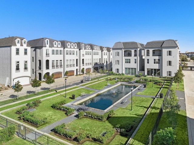 view of home's community with a swimming pool, a residential view, and fence