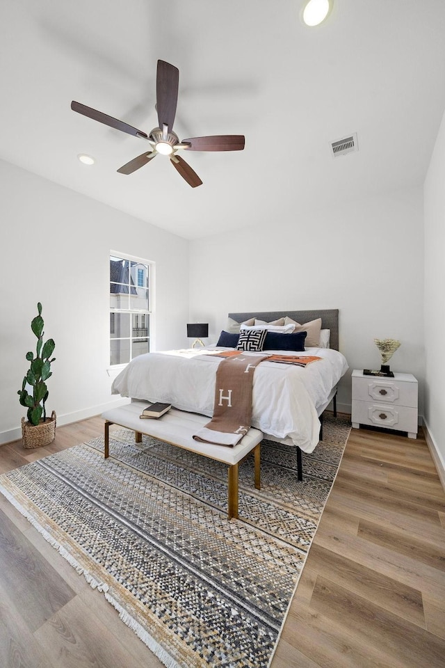 bedroom featuring recessed lighting, visible vents, a ceiling fan, wood finished floors, and baseboards