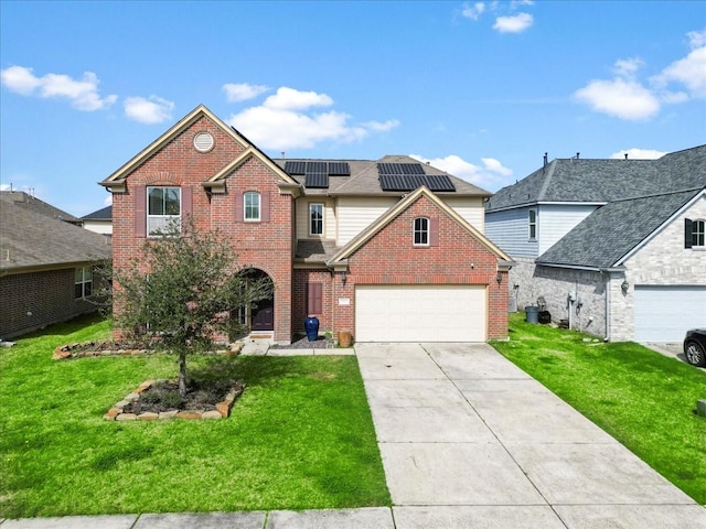 traditional-style house with driveway, brick siding, a front yard, and roof mounted solar panels