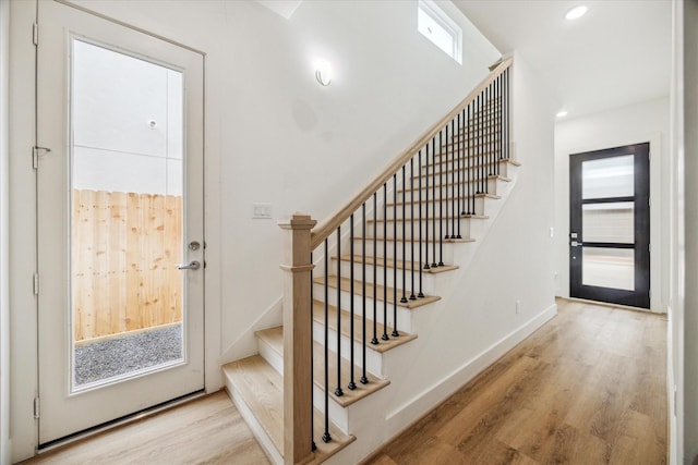 foyer featuring stairs, recessed lighting, light wood-style flooring, and baseboards