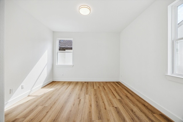 unfurnished room with light wood-style floors and baseboards