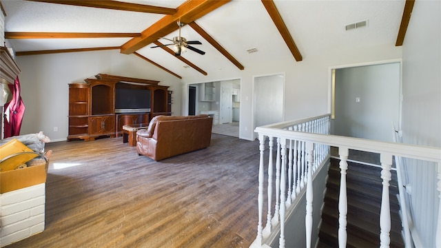 living room featuring dark wood-style floors, beam ceiling, visible vents, and high vaulted ceiling