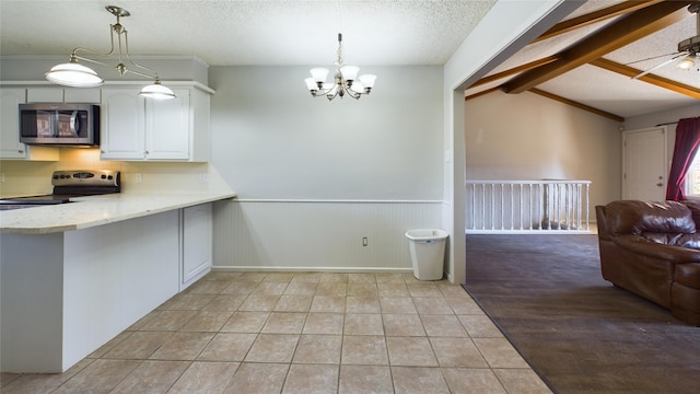 kitchen featuring stainless steel appliances, light countertops, decorative light fixtures, and white cabinetry