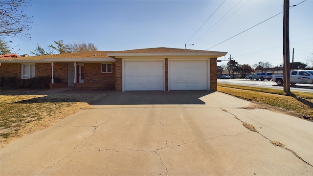 view of front of property featuring concrete driveway, brick siding, and an attached garage