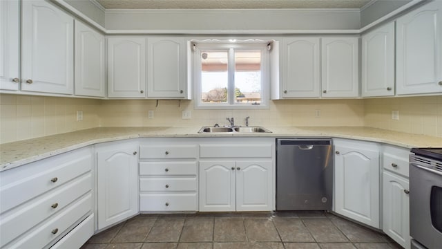 kitchen with light stone counters, stainless steel appliances, decorative backsplash, white cabinetry, and a sink