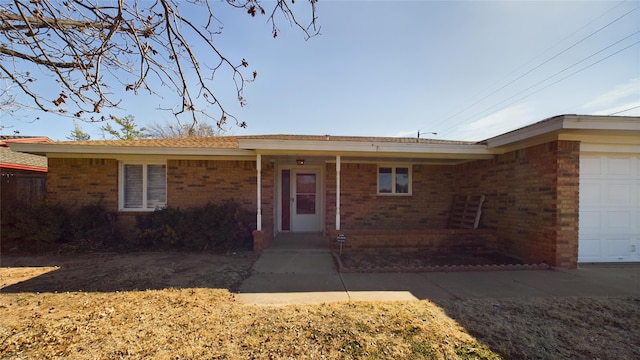 view of front of home featuring brick siding and an attached garage