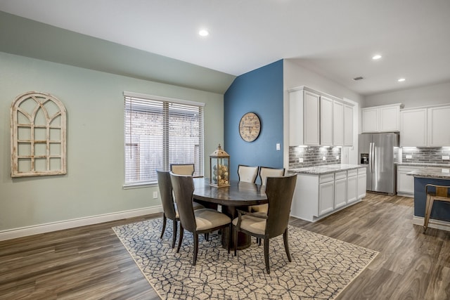 dining space with lofted ceiling, dark wood-type flooring, recessed lighting, and baseboards