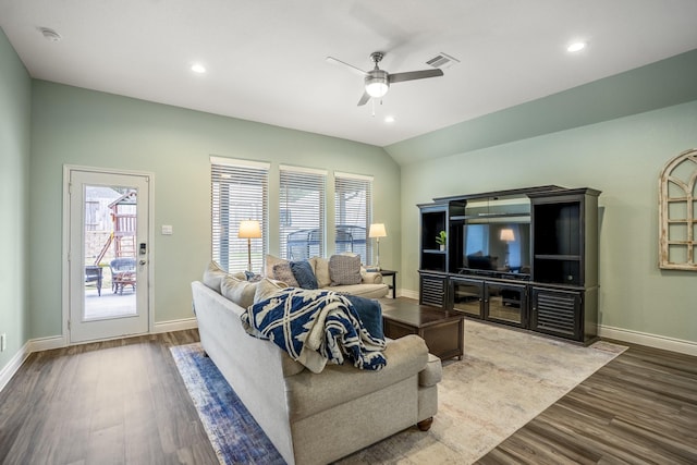 living room with plenty of natural light, baseboards, and wood finished floors