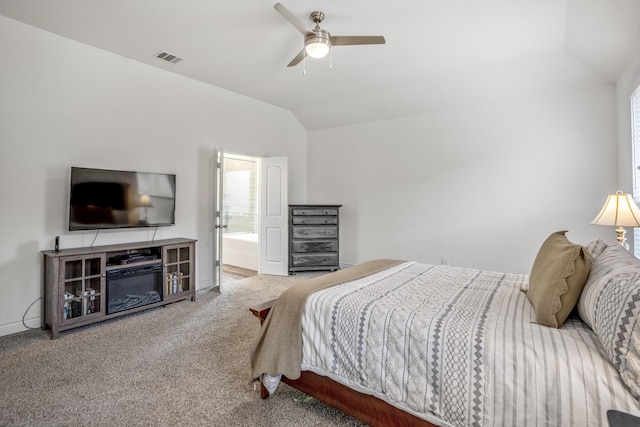 carpeted bedroom with visible vents, baseboards, lofted ceiling, ensuite bath, and ceiling fan