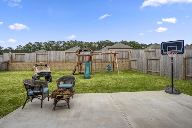 view of patio featuring a playground and a fenced backyard