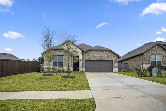 view of front of home featuring a garage, brick siding, fence, driveway, and a front yard