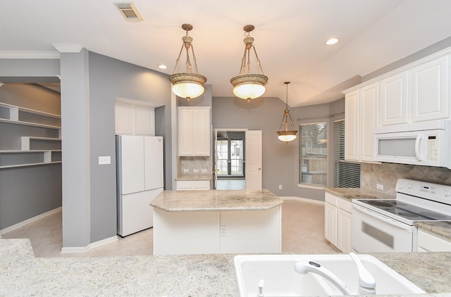 kitchen featuring white appliances, decorative light fixtures, visible vents, and white cabinetry