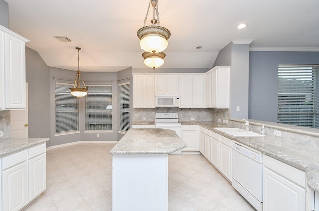 kitchen featuring white appliances, a kitchen island, a sink, white cabinetry, and pendant lighting