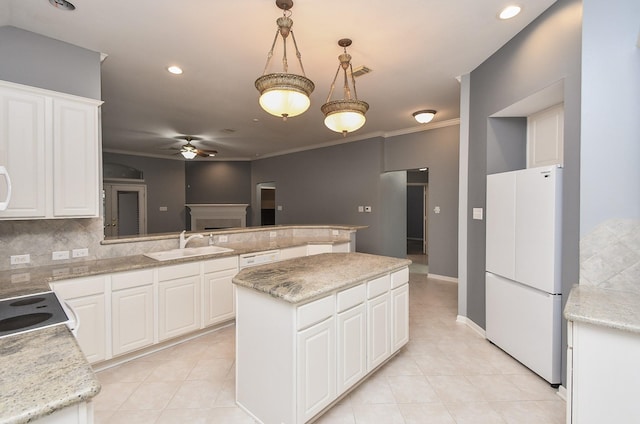 kitchen featuring pendant lighting, white appliances, white cabinetry, and a center island