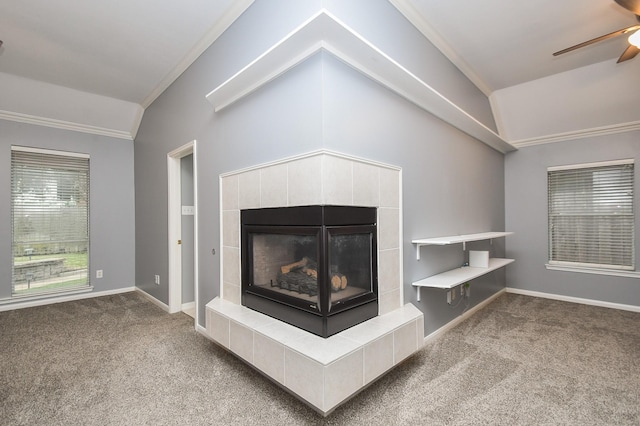 details with carpet floors, ornamental molding, a ceiling fan, a tile fireplace, and baseboards