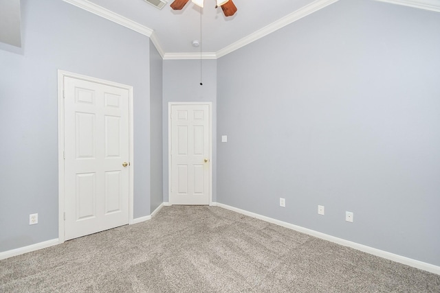 carpeted empty room with ceiling fan, ornamental molding, visible vents, and baseboards