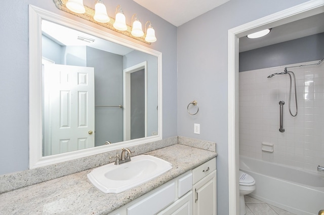 full bathroom featuring tub / shower combination, vanity, toilet, and tile patterned floors