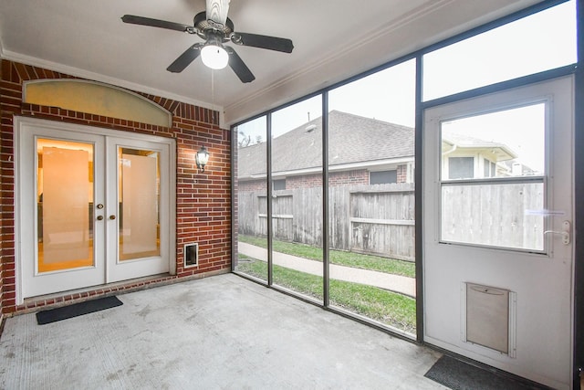 unfurnished sunroom with ceiling fan and french doors