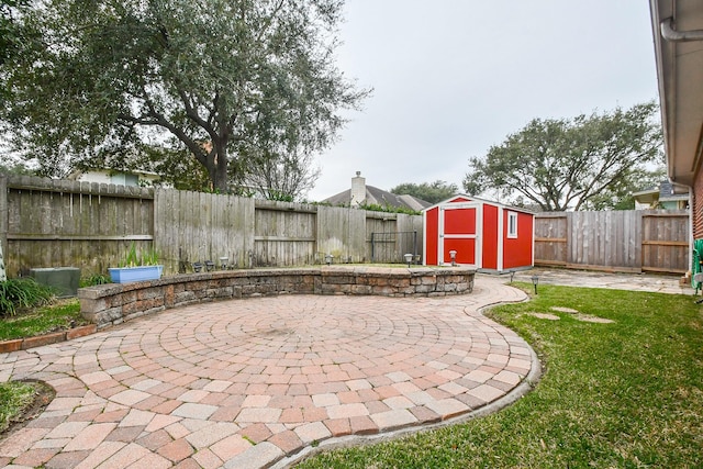 view of patio / terrace with a storage shed, an outdoor structure, and a fenced backyard