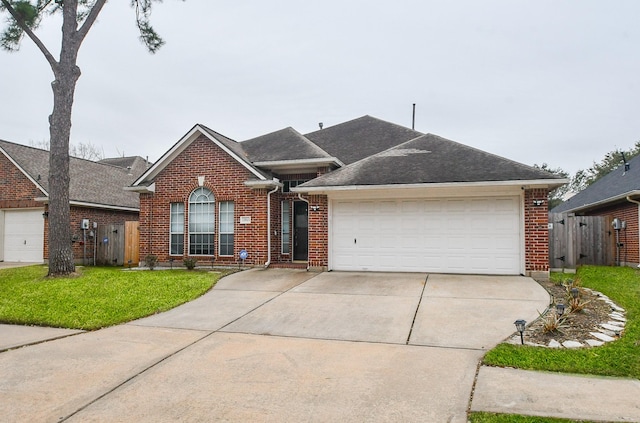 ranch-style house featuring an attached garage, driveway, brick siding, and a front yard