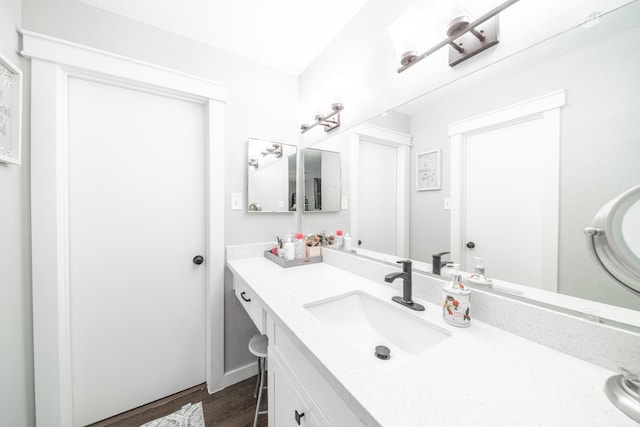 bathroom featuring wood finished floors and vanity