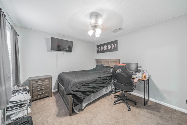 bedroom with baseboards, a ceiling fan, visible vents, and light colored carpet