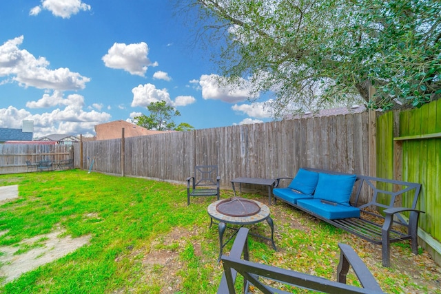 view of yard featuring an outdoor fire pit and a fenced backyard