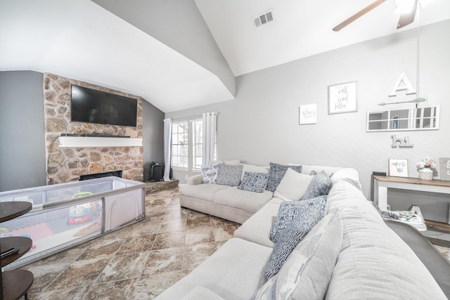 living area with visible vents, vaulted ceiling, a stone fireplace, and ceiling fan