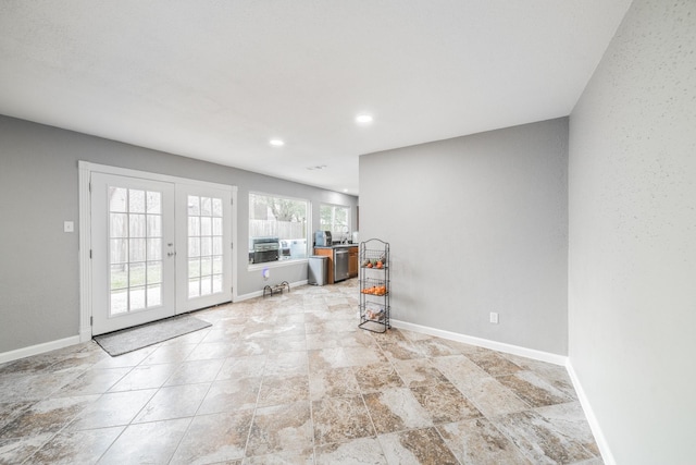 interior space with recessed lighting, baseboards, and french doors