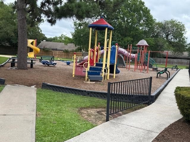 community jungle gym featuring fence