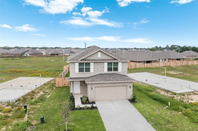 view of front of home with an attached garage, fence, driveway, a residential view, and a front yard