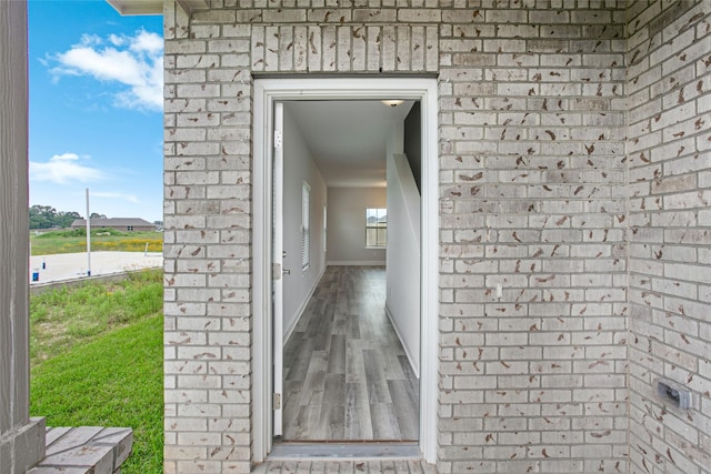 view of exterior entry with brick siding