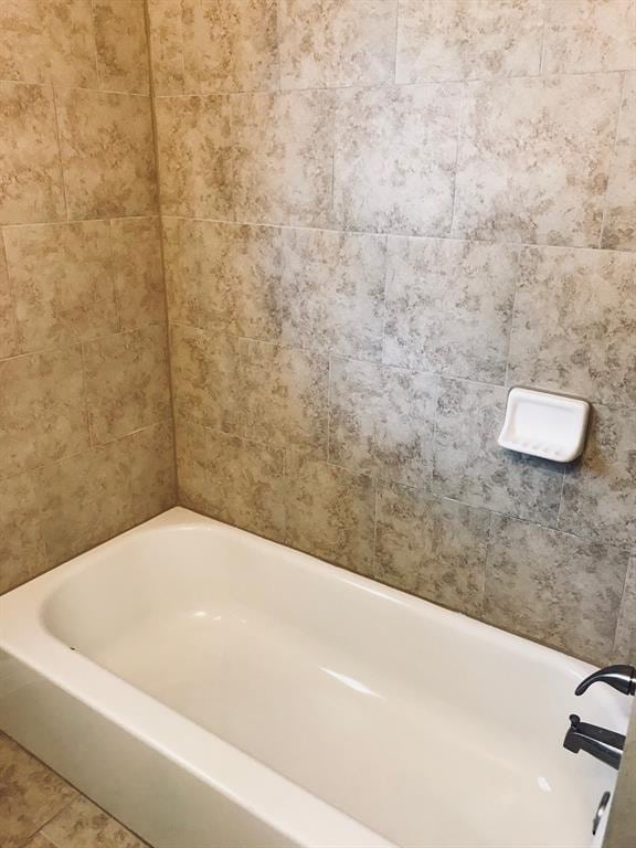 full bathroom featuring a tub and tile patterned flooring