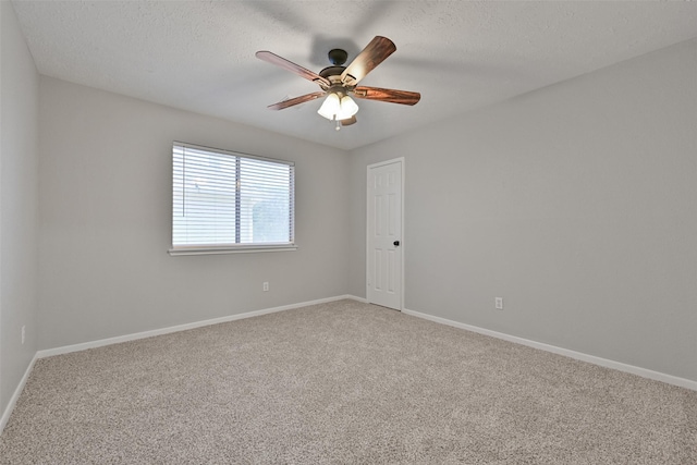 unfurnished room with baseboards, ceiling fan, a textured ceiling, and carpet