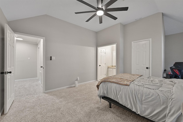 bedroom with a ceiling fan, carpet, baseboards, vaulted ceiling, and ensuite bathroom