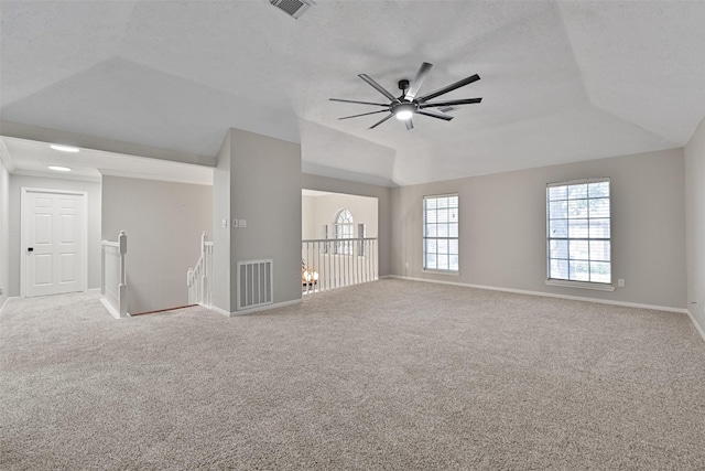 spare room with lofted ceiling, baseboards, visible vents, and carpet floors