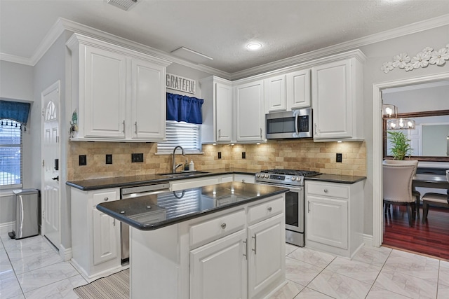 kitchen with a sink, white cabinets, appliances with stainless steel finishes, dark countertops, and marble finish floor