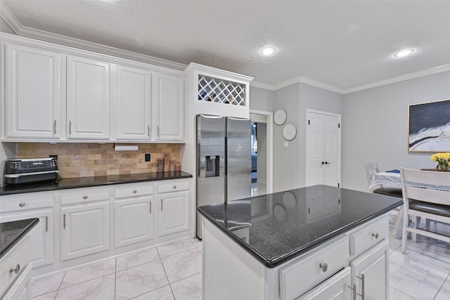 kitchen featuring crown molding, decorative backsplash, white cabinets, stainless steel refrigerator with ice dispenser, and marble finish floor