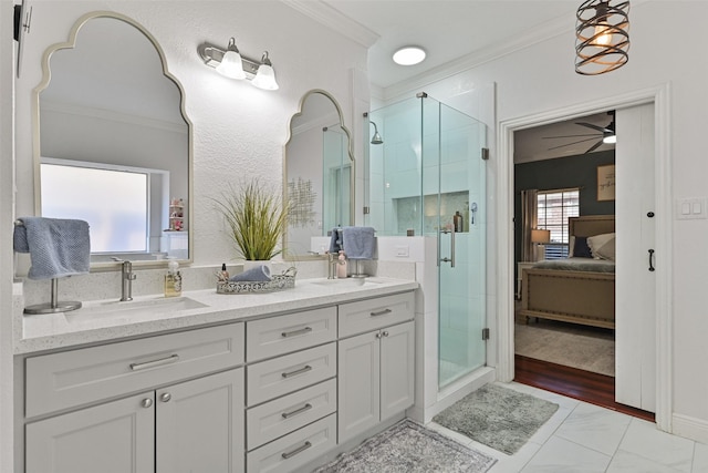 ensuite bathroom with ensuite bath, double vanity, a sink, a shower stall, and crown molding