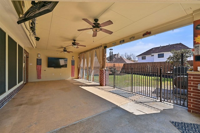 view of patio / terrace with a ceiling fan and fence