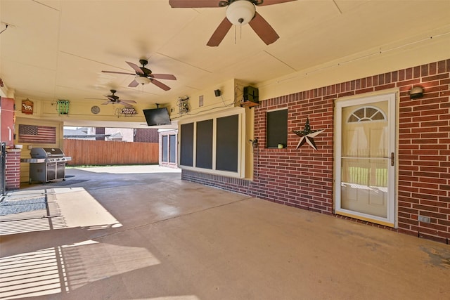 view of patio with grilling area, a ceiling fan, and fence