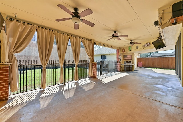 view of patio / terrace with fence and ceiling fan