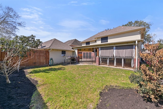 back of house with a patio area, a lawn, and fence private yard