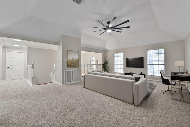 living room with visible vents, carpet flooring, baseboards, and lofted ceiling