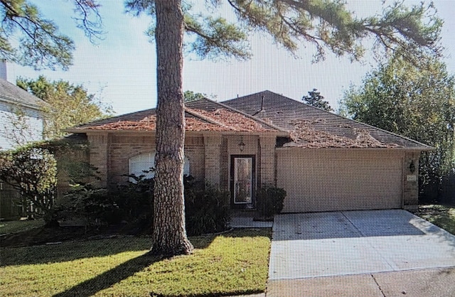 ranch-style house with a garage, driveway, and a front lawn