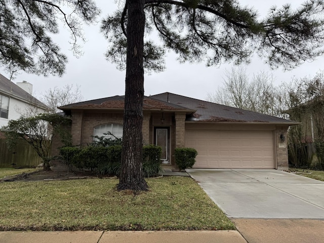 single story home with a garage, brick siding, driveway, and a front lawn