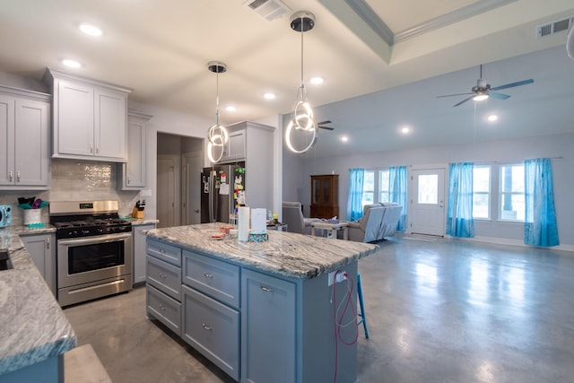 kitchen with pendant lighting, visible vents, stainless steel appliances, and open floor plan