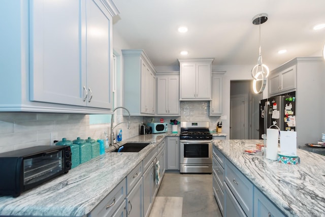 kitchen with pendant lighting, recessed lighting, decorative backsplash, appliances with stainless steel finishes, and a sink