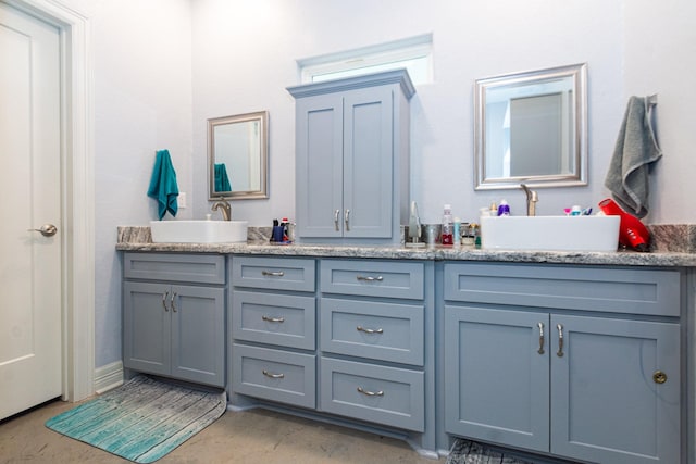 full bath featuring a sink and double vanity